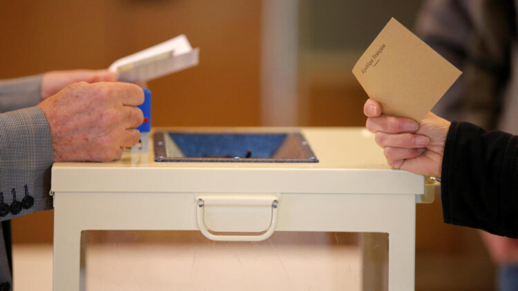 A woman prepares to cast her ballot to vote in the first round of 2017 French presidential election at a polling station in Trappes, near Paris, France, April 23, 2017. REUTERS/Vincent Kessler