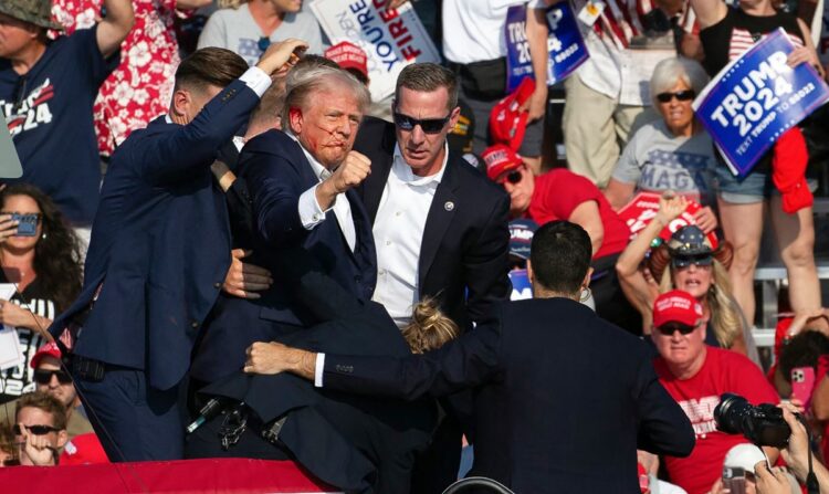 Republican candidate Donald Trump is seen with blood on his face surrounded by secret service agents as he is taken off the stage at a campaign event at Butler Farm Show Inc. in Butler, Pennsylvania, July 13, 2024. - Republican candidate Donald Trump was evacuated from the stage at today's rally after what sounded like shots rang out at the event in Pennsylvania, according to AFP.
The former US president was seen with blood on his right ear as he was surrounded by security agents, who hustled him off the stage as he pumped his first to the crowd.
Trump was bundled into an SUV and driven away. (Photo by Rebecca DROKE / AFP)