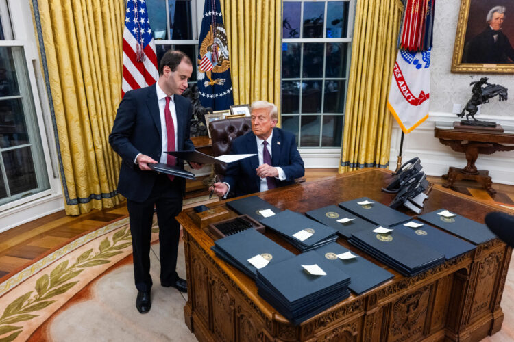 US President Donald Trump numerous executive orders, including pardons for defendants from the January 6th riots and a delay on the TikTok ban, on the first day of his presidency in the Oval Office of the White House in Washington, DC, USA, 20 January 2025. Trump, who defeated Kamala Harris to become the 47th president of the United States, was sworn in earlier in the day, though the planned outdoor ceremonies and events were cancelled due to extremely cold temperatures. Credit: Jim LoScalzo / Pool via CNP
